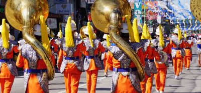 A parade band walking down a street