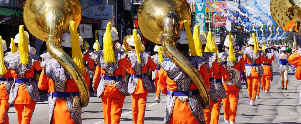 A parade band walking down a street